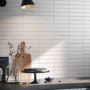 City Distressed Subway Tile White Matte 2x10 features on a contemporary kitchen backsplash