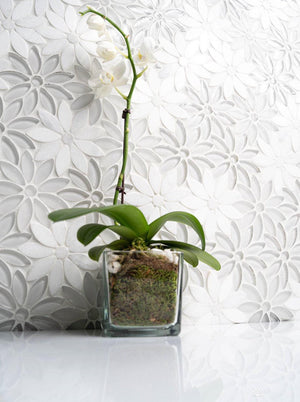 Backsplash featuring a daisy flower style mosaic tile white with a white quartz countertop 